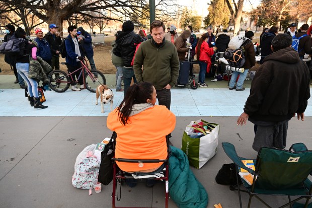Denver mayoral candidate Mike Johnston, center, talks with Danelle Montano, left, and Carlos Del Valle, right, both of whom are experiencing homelessness, about some of the issues they face on the streets on February 20, 2023 in Denver, Colorado. Thirteen Denver mayoral candidates turned out to meet with people experiencing homelessness and homeless advocates to talk about what they would do for the homeless if they were elected mayor of Denver. Candidates took questions from dozens of homeless men and women who turned out for the event. The event was organized by Mutual Aid Monday who offer food, clothing and basic supplies for the homeless every Monday afternoon outside of the City and County building. The homeless were able to have questions answered about each candidats policies about homelessness and how they might solve many of the problems facing the homeless with one of the biggest problems being housing. (Photo by Helen H. Richardson/The Denver Post)
